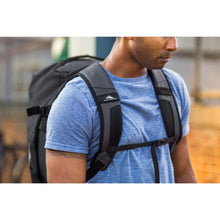 Load image into Gallery viewer, Close up to a young man carrying the duffel as a backpack.
