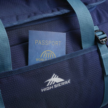 Load image into Gallery viewer, Close up to the Side duffle bag panel. A passport is partially tucked inside a quick-access pocket. 
