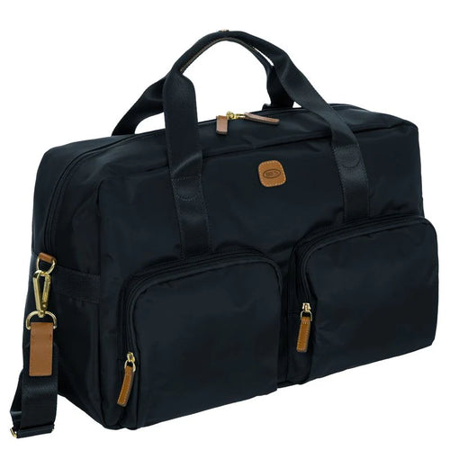 Angled front view of the duffle on a white background. It is black with tan leather accents.