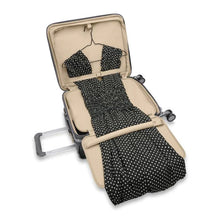 Load image into Gallery viewer, The suiter compartment with folding board shown holding a dress.

