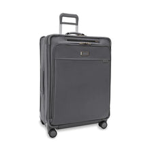 Load image into Gallery viewer, Front angled view of the suitcase with the telescopic handle partly pulled up.
