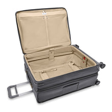 Load image into Gallery viewer, The suitcase laid down with the main compartment opened. The expandable feature is unzipped and extended.
