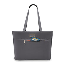 Load image into Gallery viewer, Front panel view of the steel gray traveler tote bag. The front zipper is open and a wallet is tucked partly inside. 
