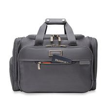 Load image into Gallery viewer, Front view of the steel gray duffle with the front zippered passport pocket opened. A passport is tucked inside.
