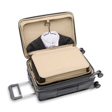 Load image into Gallery viewer, The suitcase laid down with the front panel compartment unzipped. it features a trifold section to hold suits and longer garments.
