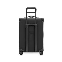 Load image into Gallery viewer, Back panel view of the black suitcase with the telescopic handle partly extended.
