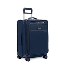 Load image into Gallery viewer, Angled front view of the navy blue suitcase with the telescopic handle partly extended.
