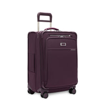 Load image into Gallery viewer, Angled front panel view of the plum suitcase with the telescopic handle partly extended.
