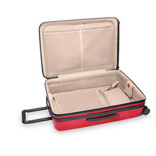 Load image into Gallery viewer, The red suitcase with the main compartment opened. It features zipper-closing pockets and a panel to hold contents.
