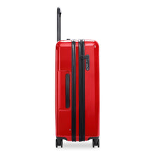 Load image into Gallery viewer, Side panel view of the red suitcase. It features a grip handle and a three-digit combination lock. 
