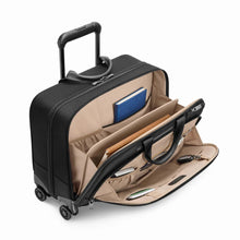 Load image into Gallery viewer, Angled view of the suitcase with the two front compartments unzipped. Both have accessories in the organization slots. 
