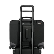 Load image into Gallery viewer, View of the spinner&#39;s Attachment feature on the back. This allows you slide along the telescoping handles of most carry-on trolley bags to secure it.
