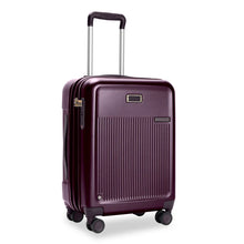 Load image into Gallery viewer, Front Angled View of the plum colored hard shell suitcase. It has a ridged front panel, and the telescoping handle partially extended.


