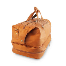 Load image into Gallery viewer, Angled side panel view of the an leather drop down bottom duffle bag. The grip handles are pulled up. 
