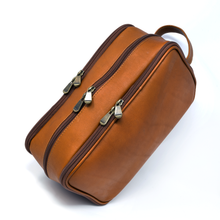 Load image into Gallery viewer, Angled top view of the tan leather shaving kit bag with three zipper compartments.
