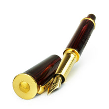 Load image into Gallery viewer, Angled front view of the red and gold fountain pen. 
