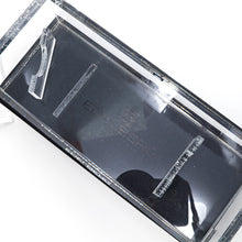 Load image into Gallery viewer, Interior view of the tansparent presentation box. One of the pen holders has become detached. 
