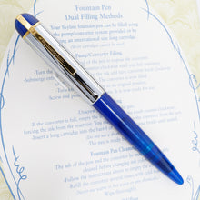 Load image into Gallery viewer, Front view of the fountain pen with the cap on. Laid on top of the certificate. 

