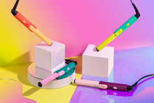 Load image into Gallery viewer, The four hair curlers arranged on a vibrant background
