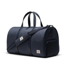 Load image into Gallery viewer, Front angled view of the duffle bag with the strap across the front. 
