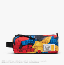 Load image into Gallery viewer, Front view of the settlement pouch with vibrant abstract Lego print.
