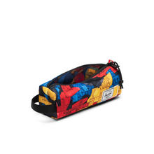 Load image into Gallery viewer, Angled view of the settlement pouch with vibrant abstract Lego print. The main compartment is unzipped.
