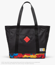 Load image into Gallery viewer, Front panel view of the black tote bag with colorful Lego brick pattern at the bottom.
