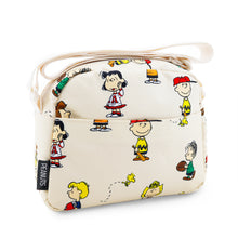 Load image into Gallery viewer, Angled back panel view of the Peanuts pattern crossbody bag with the folded shoulder strap resting on the top.
