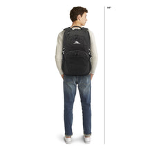 Load image into Gallery viewer, A six foot six man carrying the black backpack. 
