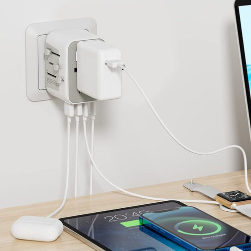 The adapter shown connected to a wall plug and charging different devices. 