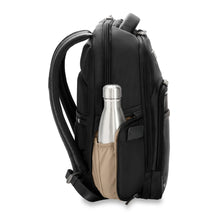 Load image into Gallery viewer, Side panel view of the black backpack.  A metal water bottle is stored on the opened  pocket. 
