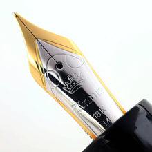 Load image into Gallery viewer, Close up to the fountain pen with engraved decorations, KRONE logo, 18K gold hallmark, and the letter M.
