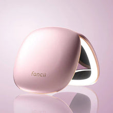 Load image into Gallery viewer, Angled view of the pink pocket mirror, unfolded and facing down. The light is set on.

