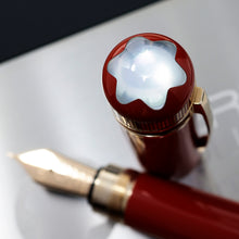 Load image into Gallery viewer, Close up to the top of the cap with the pen nib on the background.
