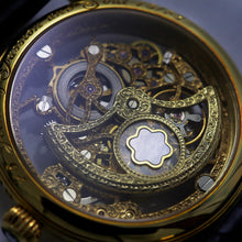 Load image into Gallery viewer, Close-up of a gold mechanical watch face with intricate details
