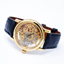 Load image into Gallery viewer, Gold mechanical watch with a black leather strap on a white background
