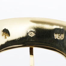 Load image into Gallery viewer, Close up to the 750 solid gold hallmarks engraved on the watch buckle. 
