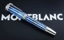 Load image into Gallery viewer, The blue and silver striped Montblanc pen resting diagonally on a black background with the white Montblanc logo behind it.
