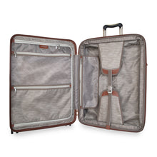 Load image into Gallery viewer, Interior view of the suitcase. It features a zipper-closing panel divider with pockets and adjustable straps. 
