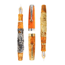 Load image into Gallery viewer, Uncapped Montegrappa Chinese Zodiac Tiger fountain pens in gold and silver overlay, featuring intricate Tiger engravings on Orange resin bodies, displayed on a white background.
