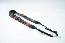 Load image into Gallery viewer, The tapestry design strap, folded on a white background.

