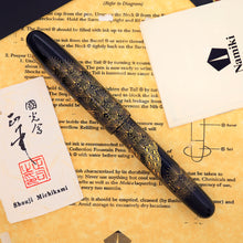 Load image into Gallery viewer, Decorative fountain pen on a paper background with the artist card.
