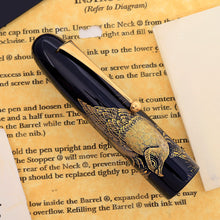 Load image into Gallery viewer, Fountain pen cap with hawk design on a paper background.
