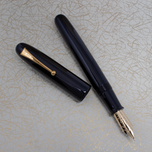 Load image into Gallery viewer, The fountain pen and cap arranged on top of the outer box.

