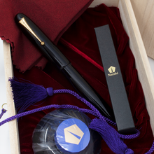 Load image into Gallery viewer, The fountain pen arranged in the presentation box with the ink bottle, eye dropper box, and red cloth.
