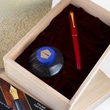Load image into Gallery viewer, The fountain pen arranged in the presentation box with the ink bottle, certificates, and outer box.

