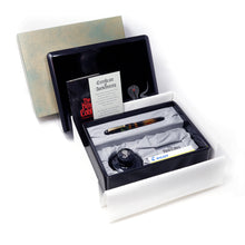 Load image into Gallery viewer, The fountain pen arranged with the presentation box, certificates, ink bottle, and outer box.
