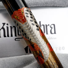 Load image into Gallery viewer, Close up to the red cobra design on the pen barrel.
