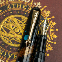 Load image into Gallery viewer, Close Up to the Fountain Pen clip and nib. They are both golden in color. 
