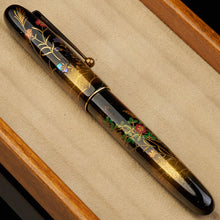 Load image into Gallery viewer, Decorative pen with floral designs on a beige cushion
